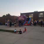Employees and kids having a company party with a bounce house at Gadellnet IT Solutions in St. Louis, MO