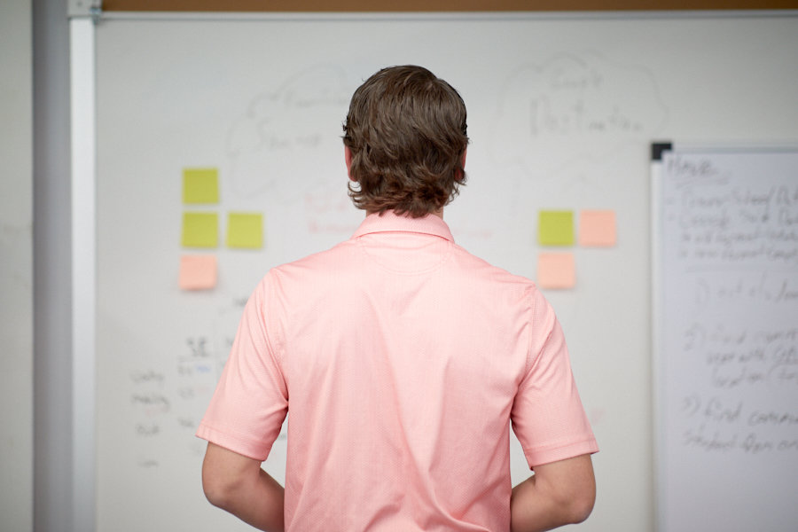 Employee looking a whiteboard with notes