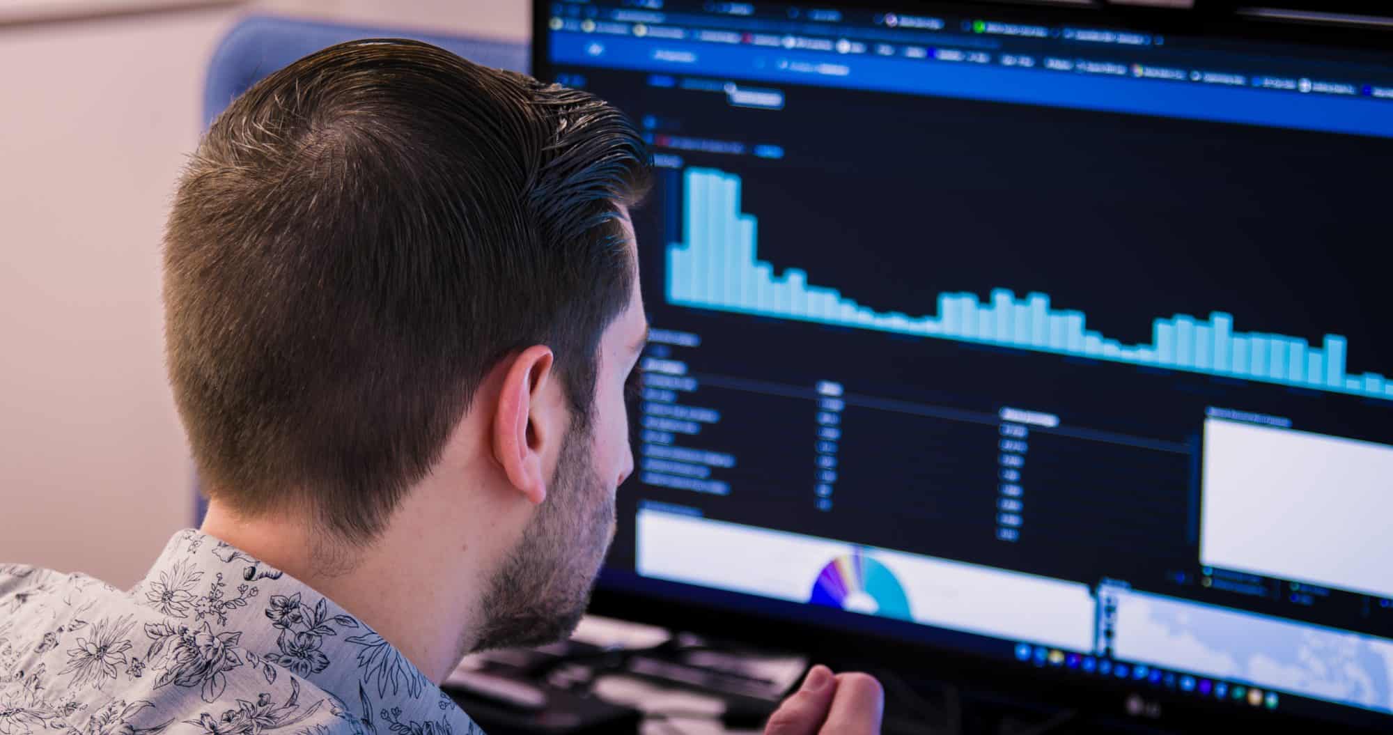 Cybersecurity engineer looking at a computer