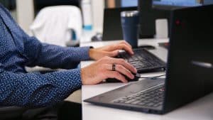 IT employee working on a keyboard in a modern workplace