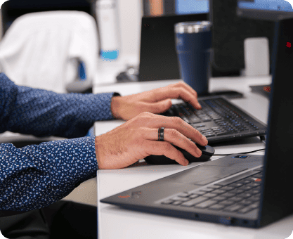 IT employee working on a keyboard in a modern workplace